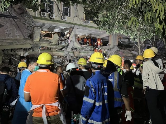 Rescue workers seek to free a pregnant woman trapped in the ruins of Sky Villa in Mandalay, central Myanmar. Credit: IPS Reporter
