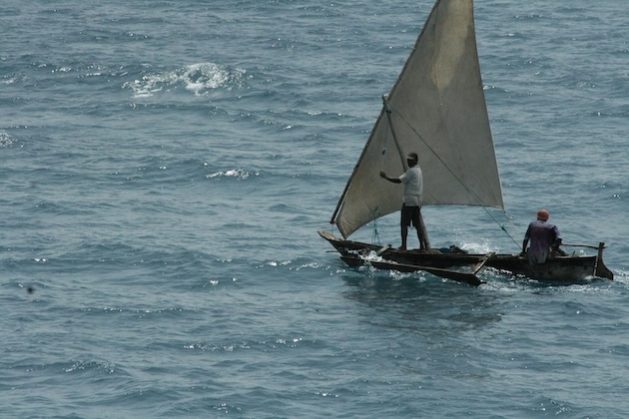 Fishermen gliding on a canoe off the coast of Dar es Salaam. Photo by Kizito Makoye