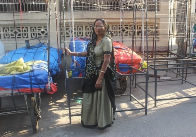 Street vendor Deviben Dhaundhaliya waits by her iron-frame mobile ‘shop’ to be shifted to the marketplace for evening-time sales in Ahmedabad city in Gujarat state. Credit: Manipadma Jena/IPS