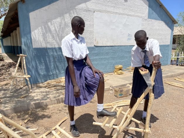 Magdalene Ngimoe and Char Tito, learners at Kakuma Arid Zone Secondary School, making chairs from mathenge wood. Credit: Farai Shawn Matiashe/IPS
