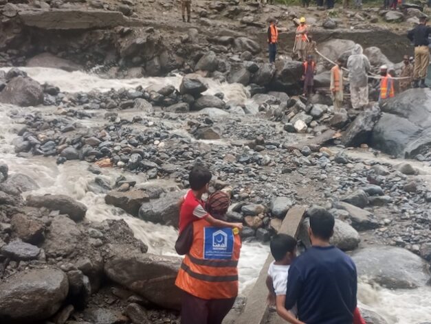 Rescuers carry children away from their flood-devastated village in the Buner region in Khyber Pakhtunkhwa (KP) province. The region Credit: Al Khidmat Foundation