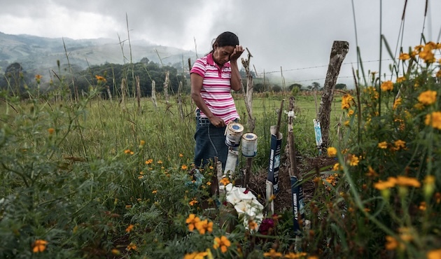 Julia Francisco Martínez stands at the graveside of her husband Juan, a Honduran Indigenous defender who was found murdered in 2015. Credit: Giles Clarke / Global Witness