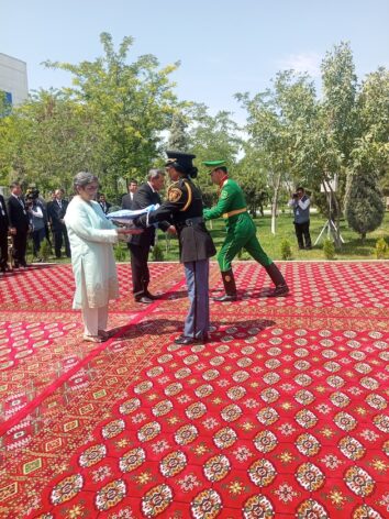 Uniformed marines hand over UN and Turkmenistan flags to UN special representative on LLCDs Rabab Fatima and Turkmenistan's Foreign Minister Rashid Meredov during a flag lowering ceremony in Awaza. Credit: Kizito Makoye/IPS