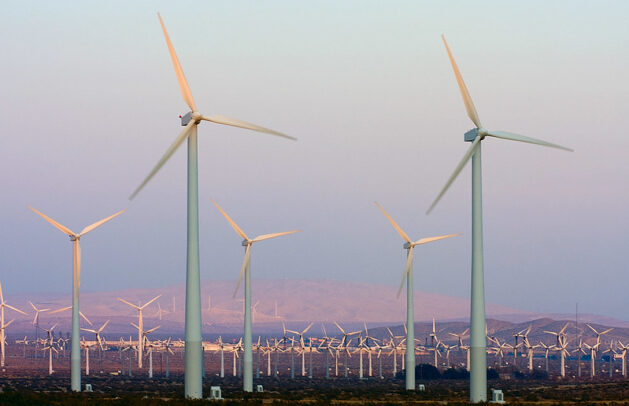 A large wind farm of turbines on the flat landscape of California. Credit: Climate kcdsTM