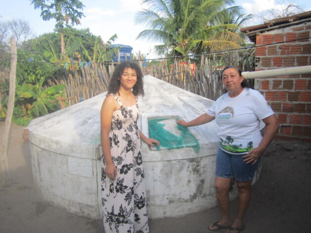 The rainwater harvesting cistern is everywhere in Brazil's semi-arid region, a social technology that reduced water scarcity for its inhabitants. Elizabete Sousa Soares wanted to leave Jatobá when her daughter Maria was born 11 years ago, but decided to stay in her small rural town thanks to the cistern and other social technologies that have improved her life. Credit: Mario Osava / IPS