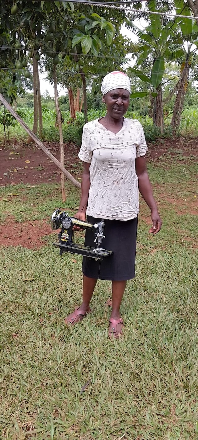 Alice Onyango shows off a sewing machine she bought with the proceeds of the My Farm Trees project. Credit: Wilson Odhiambo/IPS