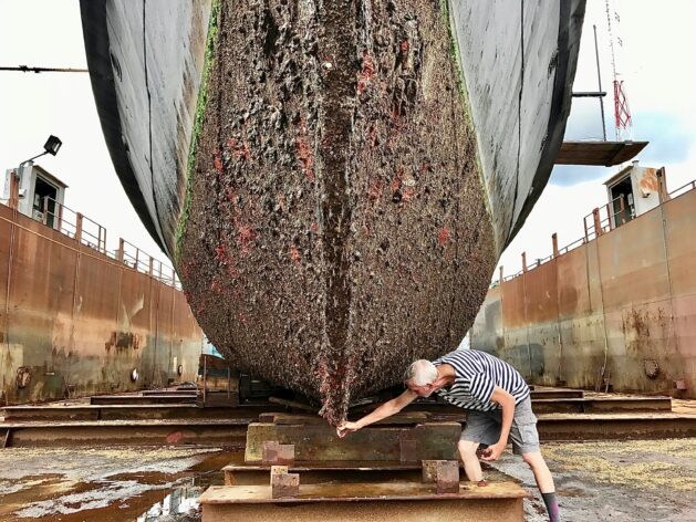 One of the biggest hidden threats to ocean health comes from biofouling — the accumulation of algae, barnacles and microorganisms on ships’ hulls that can transport invasive species across oceans. Credit: Aaron Smulktis/Unsplash