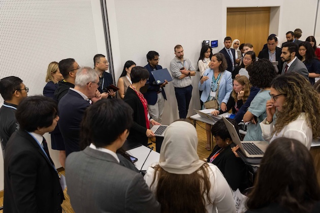 Delegates huddle during the informal consultations on cooperation with other international organisations. The climate talks in Bonn were long and tense. Credit: IISD/ENB/Kiara Worth