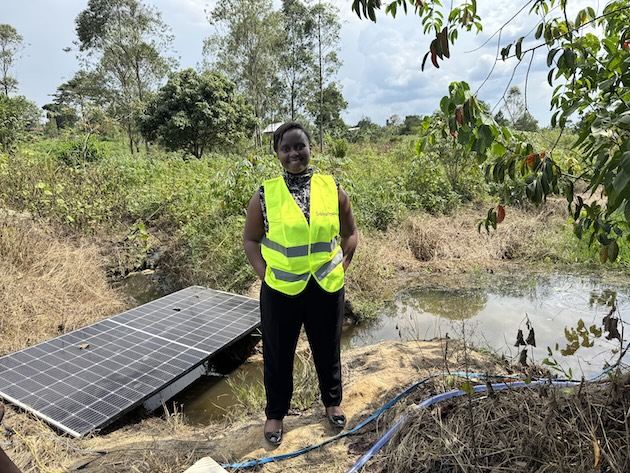 Shifra Ainomugisha poses beside a solar-powered irrigation system in Uganda. She is combining renewable energy and AI-enabled agricultural support to help smallholder farmers increase productivity and reduce post-harvest losses. Credit: Solar Farm Uganda