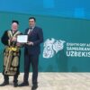 Claude Gascon, interim CEO of the GEF and Aziz Abduhakimov, Minister of Environment of the Republic of Uzbekistan, at the closing ceremony of the Eighth GEF Assembly in Samarkand, Uzbekistan. Gascon was presented with a traditional Uzbek outfit. Credit: Stella Paul/IPS
