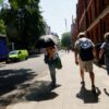 A person uses an umbrella to keep cool during a heatwave in London, England, in June 2026. Credit: Alastair Johnstone-Hack / Climate Visuals