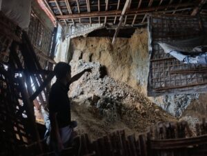 A Rohingya refugee points to the landslide that killed two of Abdu Rozork’s...<a href=