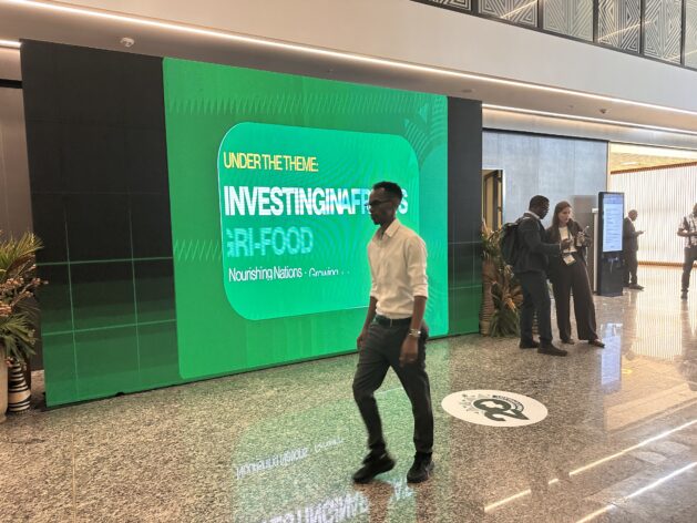 A delegate walking past a billboard at the Africa Food Systems Forum at Kigali Convention Centre in Rwanda's capital. Credit: Farai Shawn Matiashe/IPS