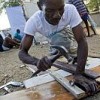 A displaced Haitian man builds a makeshift shelter at Port-au-Prince's golf course where many like him have set up temporary homes. Credit: UN Photo/Marco Dormino 