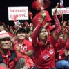 'Red shirts', as supporters of ousted Thai PM Thaksin Shinawatra are called, cheer after listening him speak from Dubai. Credit: Marwaan Macan-Markar/IPS