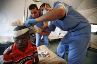 A young earthquake victim is treated at an impromptu hospital established by the Jordanian battalion of the U.N. peacekeeping mission. Credit: UN Photo/Sophia Paris