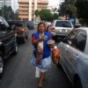 Carol Orozco hawking candy at a busy intersection in Guatemala City. Credit: Danilo Valladares/IPS 