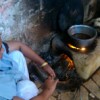 Roma Juma makes tea for guests using her smoke-free stove. Credit: Zofeen Ebrahim/IPS