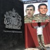 A protester holds a banner depicting British Prime Minister Gordon Brown and Foreign Secretary David Miliband in Tiger uniform. Credit: Sanjaya Nallaperuma/IPS