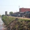Polluted river by a shanty town in Argentina.  Credit: Courtesy UN-HABITAT