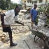 A Port-au-Prince man clears the debris of what was once his home into the street of the city's Turgeau neighbourhood. Credit: UN Photo/Sophia Paris 