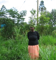 Agnes Mbuvi amidst the napier grass in her harvested maize plot.  Credit:  Keya Acharya/IPS