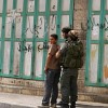 Israeli soldiers using a Palestinian boy as a human shield in Beit Ummar.  Credit: Mel Frykberg/IPS