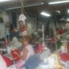 Women at a cooperative making shirts that are red, the president's trademark colour.  Credit: Humberto Márquez/IPS