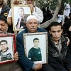 Families of Palestinians prisoners hold up their pictures at a protest in Gaza city.  Credit: Mohammed Omer/IPS