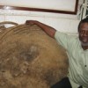 Dr. Gilbert Ouma with a cross section of a Shibelenge tree traditionally used in rainfall prediction. Credit: Isaiah Esipisu/IPS