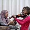 Rita, 9, learning the basics of the violin. Credit: Emad Badwan