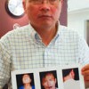 Petitioner Xu Cong Yang holds images of himself bloodied and bruised as a result of his detention in one of China's 'black jails'. Credit: Gordon Ross/IPS