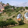 Pescomaggiore village with its new straw and wood houses (foreground). Credit: Stefania Milan/IPS