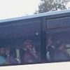 Activists being deported from Ben Gurion airport flash the 'V' sign through the darkened windows of a bus. Credit: Mel Frykberg/IPS