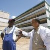 Modesto Bravo, head of construction, converses with Dr. Yosvany Tamayo, director of Héroes del Baíre Hospital, in Nueva Gerona, Cuba.  Credit: Jorge Luis Baños/IPS