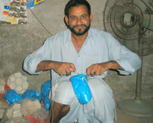 Hand-stitched footballs being put together in Pakistan, which used to supply most of the world's supply of them. Credit: Irfan/IPS