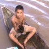 A boy holds up oil sludge from the Marañón River in the Peruvian Amazon. Credit: Federación de Comunidades Nativas del Río Corrientes