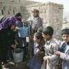 Children help an old woman fill her containers with water from a community pump in Dobra Khira near Sanaa, Yemen. Credit: UN Photo/Ian Steele