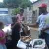 Gaston Dorelus sells ice cream on a stick to local children. Credit: Jon Anderson/IPS