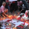 Red shirt protesters light candles at an impromptu shrine in downtown Bangkok. Credit: Marwaan Macan-Markar/IPS