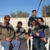 Rachel Corrie (right) and a local family in Gaza. Credit: Courtesy of Women Make Movies