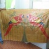 Nenzinho holds up wall hanging made of latex fabric. Credit: Mario Osava/IPS 