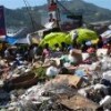Giant campaign billboard dwarfed by a mountain of garbage in Petion-ville. Credit: Courtesy of Acessomedias