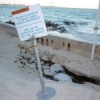 "Paradise also needs maintenance," states a sign outside a Cancún hotel, where sand is eroding away. Credit: Diana Cariboni/IPS