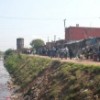 A slum on the banks of a polluted stream. Credit: UN-HABITAT