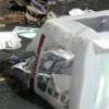 A ballot box floats in garbage-filled puddles next to the polling station at Building 2004 in the neighbourhood of Delmas. Credit: Wadner Pierre/IPS