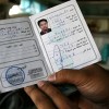 Former OFW Exequel Masucal displays his green card from Libya. Credit: Kara Santos/IPS