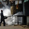 A health worker fumigates suspected mosquito breeding grounds in Colombo. Credit: Sanka Gayashan/IPS