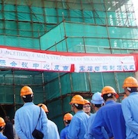 Shanghai Construction Company workers outside Malawi's new five-star hotel. Credit:  Claire Ngozo/IPS