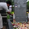 A colleague lights candles at the grave of assassinated editor Lasantha Wickrematunge. Credit: Amantha Perera/IPS